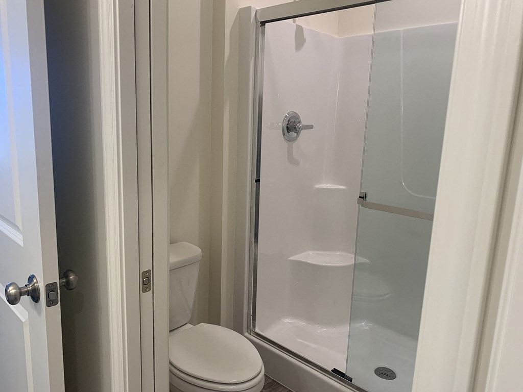 a small bathroom with a shower and a toilet