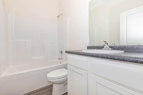 a white bathroom with a sink and a toilet