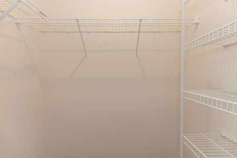 the walk in closet in the master bedroom of a home