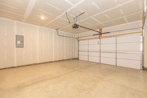 the interior of a white garage with white walls and doors