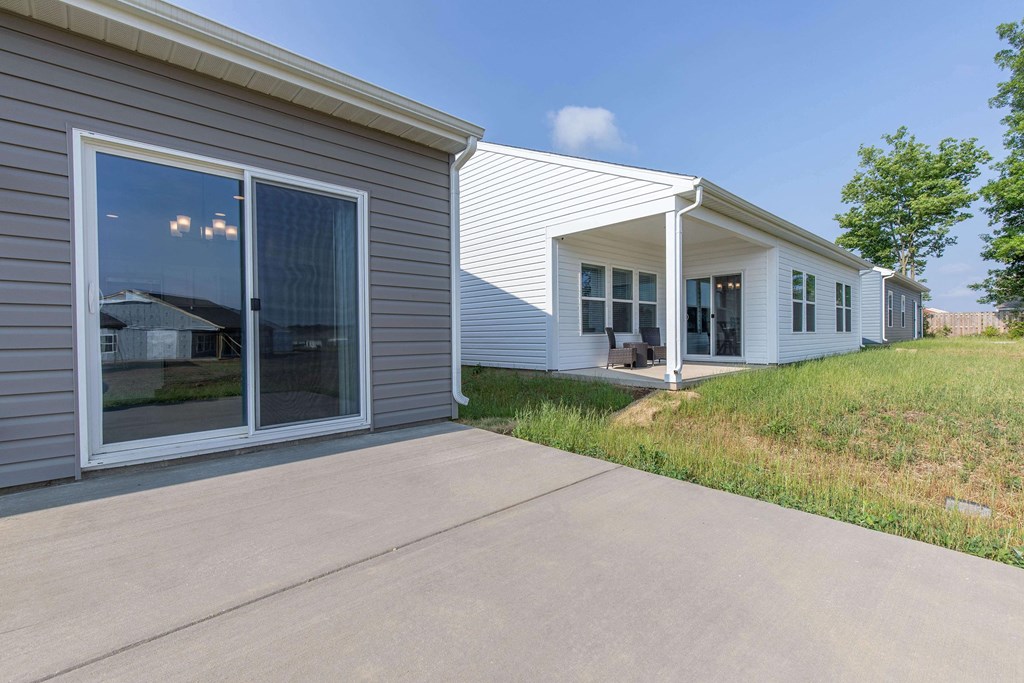 a view of the front of a house with a cement driveway