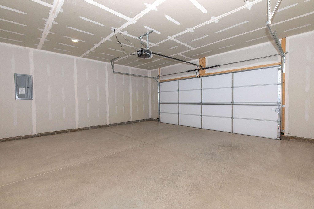 the inside of a garage with white walls and doors