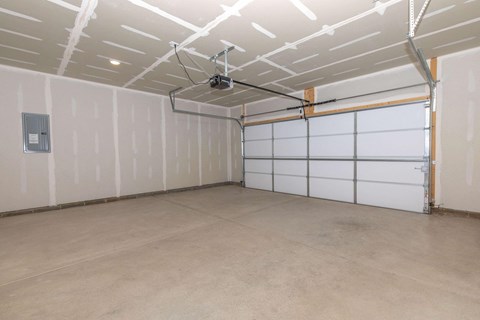 the inside of a garage with white walls and doors