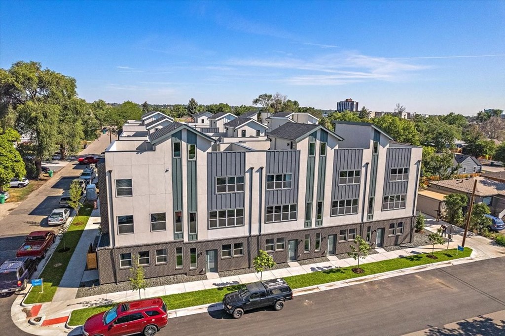 an aerial view of a building with cars parked in front of it