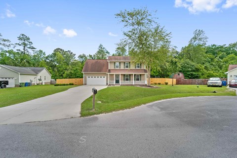 a house with a driveway and a street in front of it