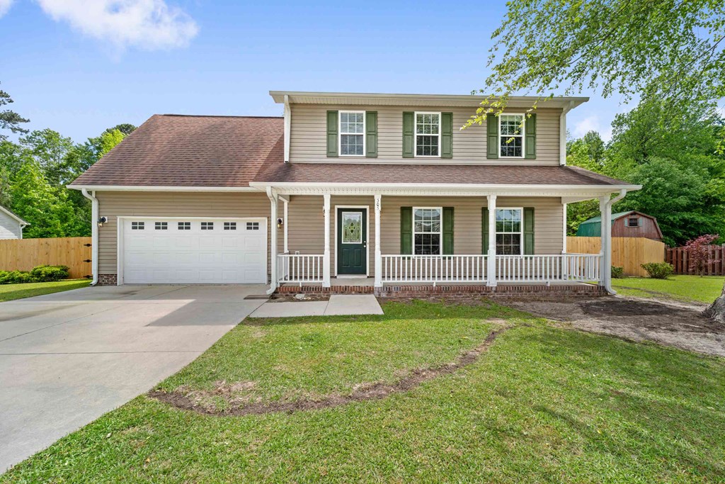 a house with a driveway and a white garage door