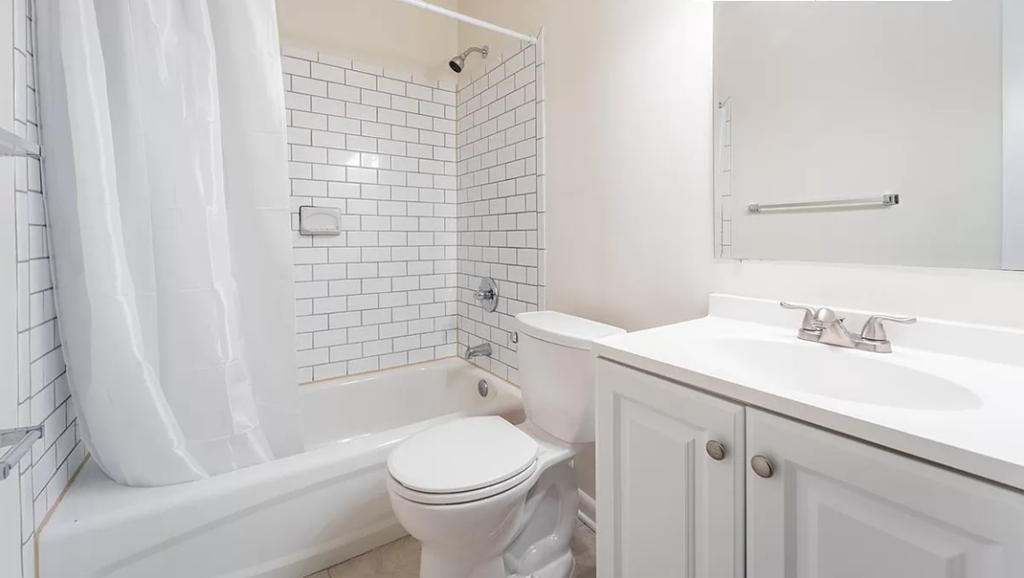 a white bathroom with a sink toilet and tub