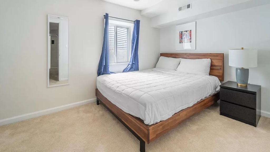 a bedroom with a bed and a window