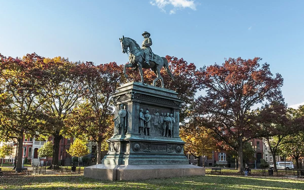 a statue of a man riding a horse in a park
