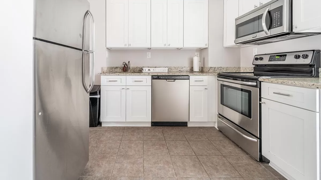 a kitchen with stainless steel appliances and white cabinets