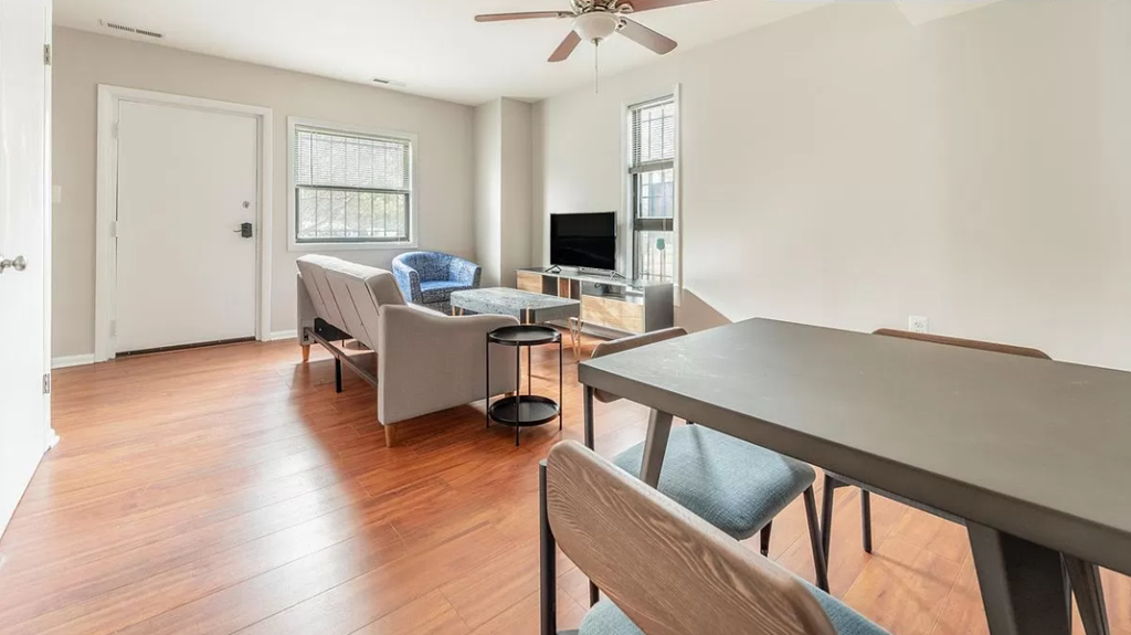 a living room with a dining room table and a couch