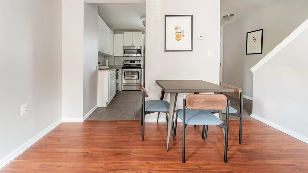 a dining room with a table and chairs and a kitchen