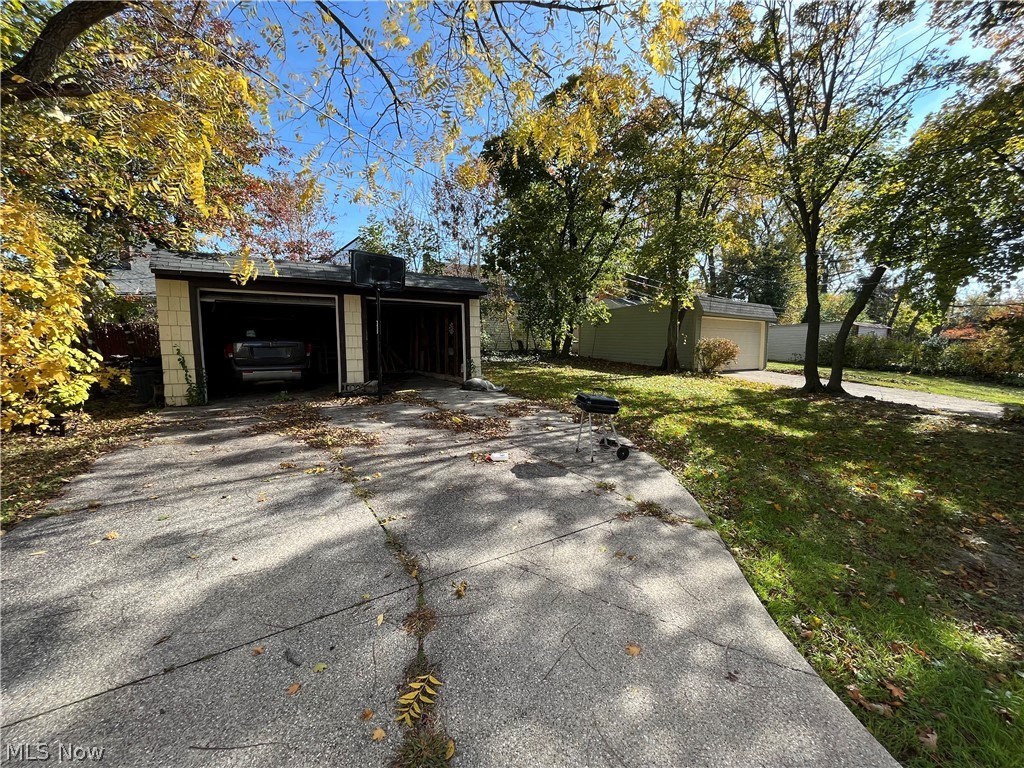 a garage with a driveway in front of a house