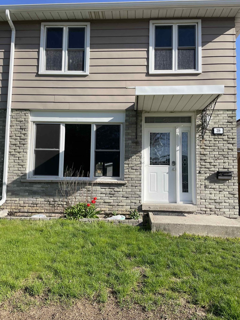 the front of a house with a white door
