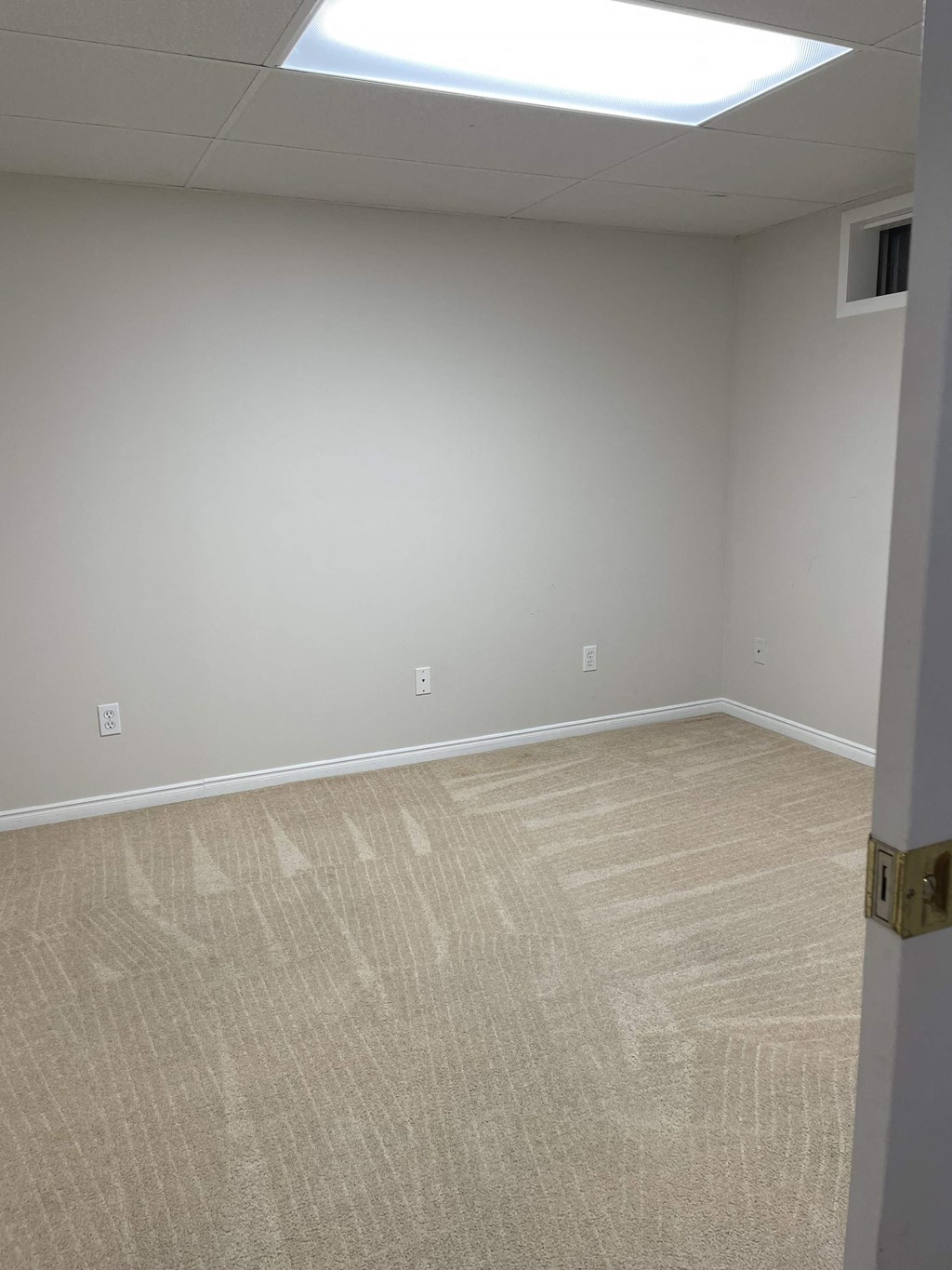 a room with a carpeted floor and a window