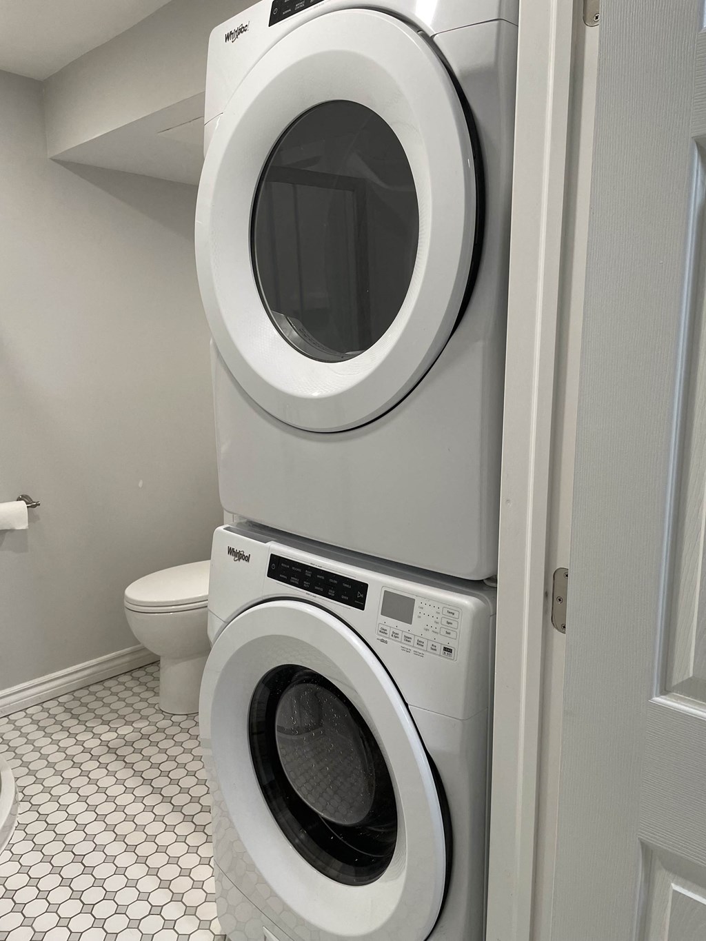 a washing machine and a toilet in a bathroom