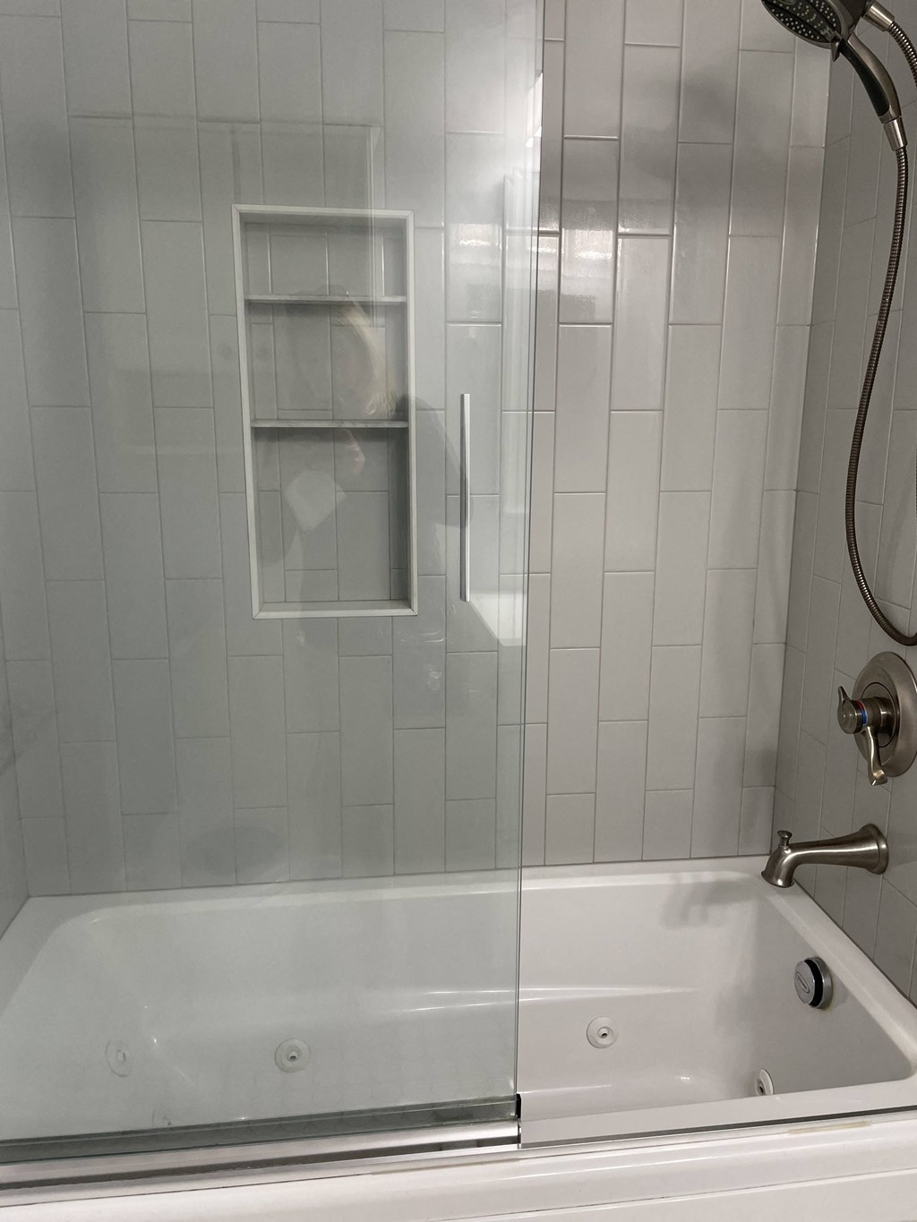 a bathroom with a shower and a bath tub