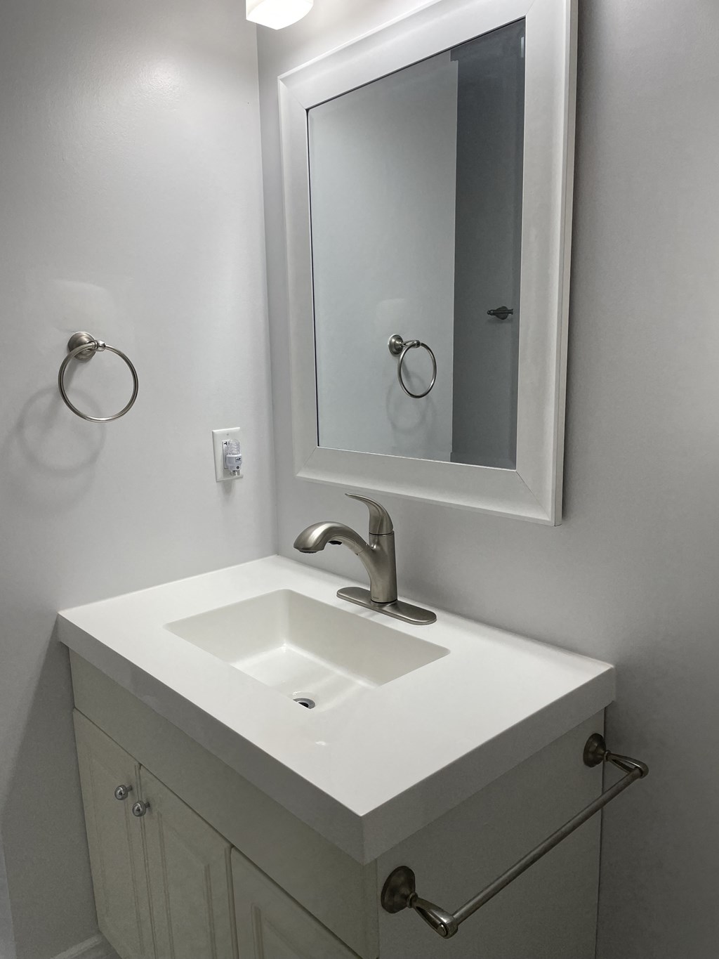 a small bathroom with a sink and a mirror