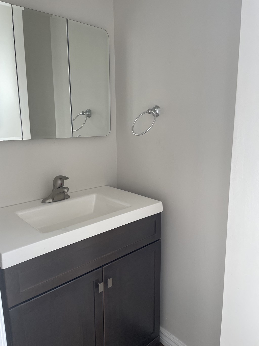 a small bathroom with a sink and a mirror