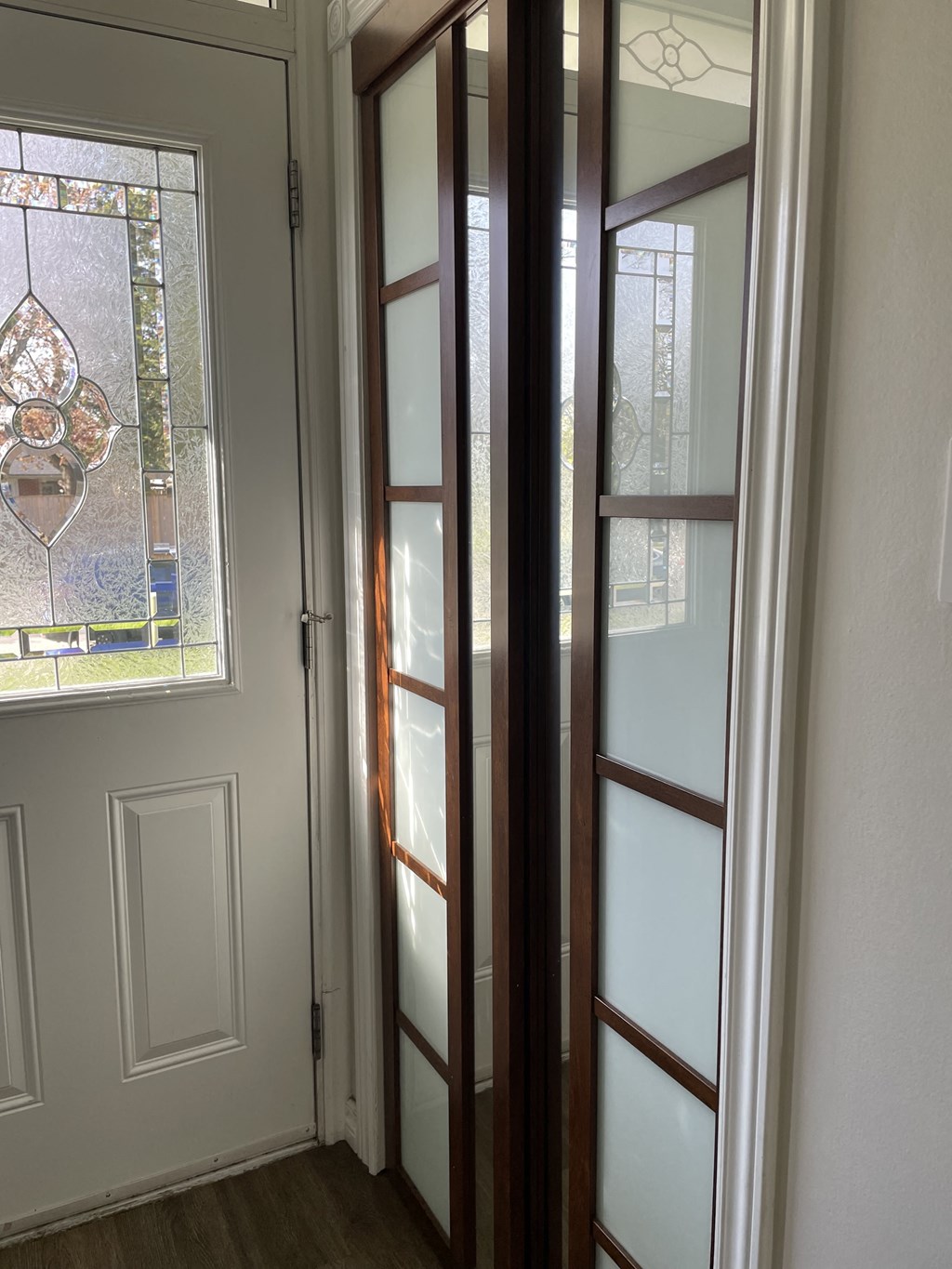 a pair of glass doors in a room with a window