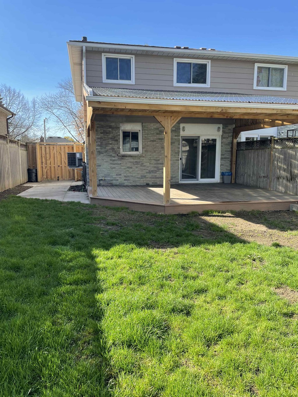 a view of the back of a house with a yard