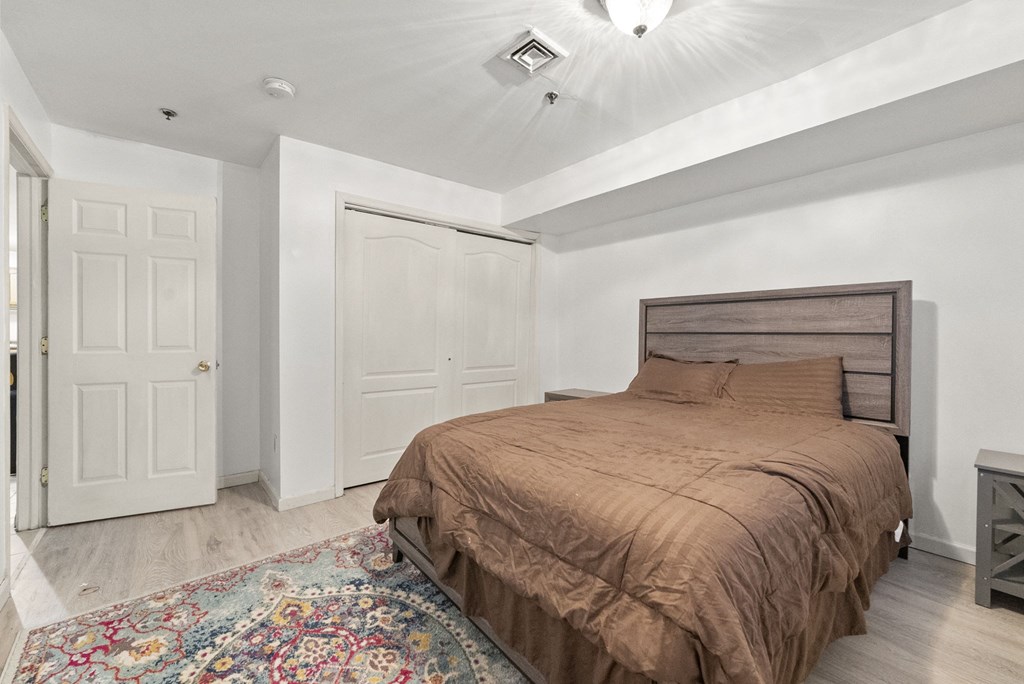 a bedroom with a bed and a closet