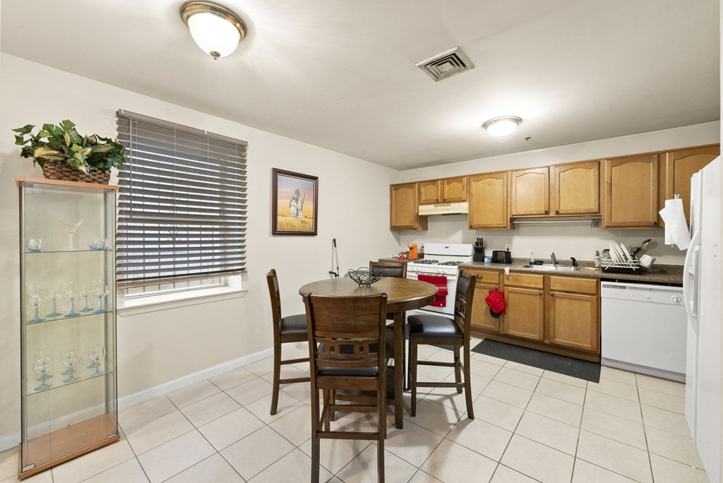 a kitchen with a dining table and a refrigerator