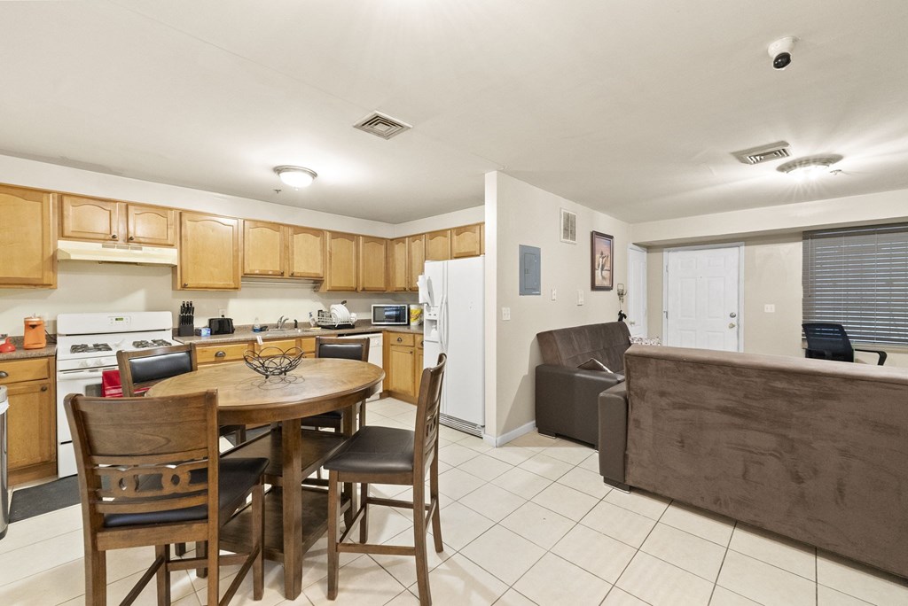 a kitchen and dining area with a wooden table and chairs