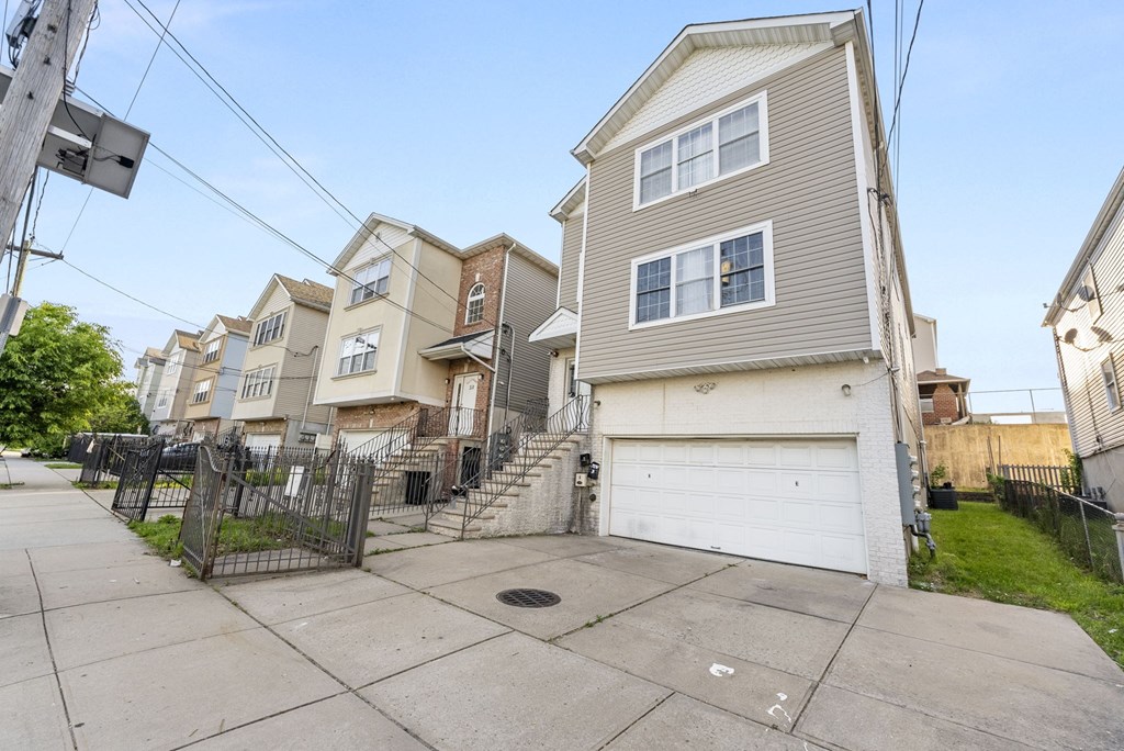 the front of a row of houses with a sidewalk