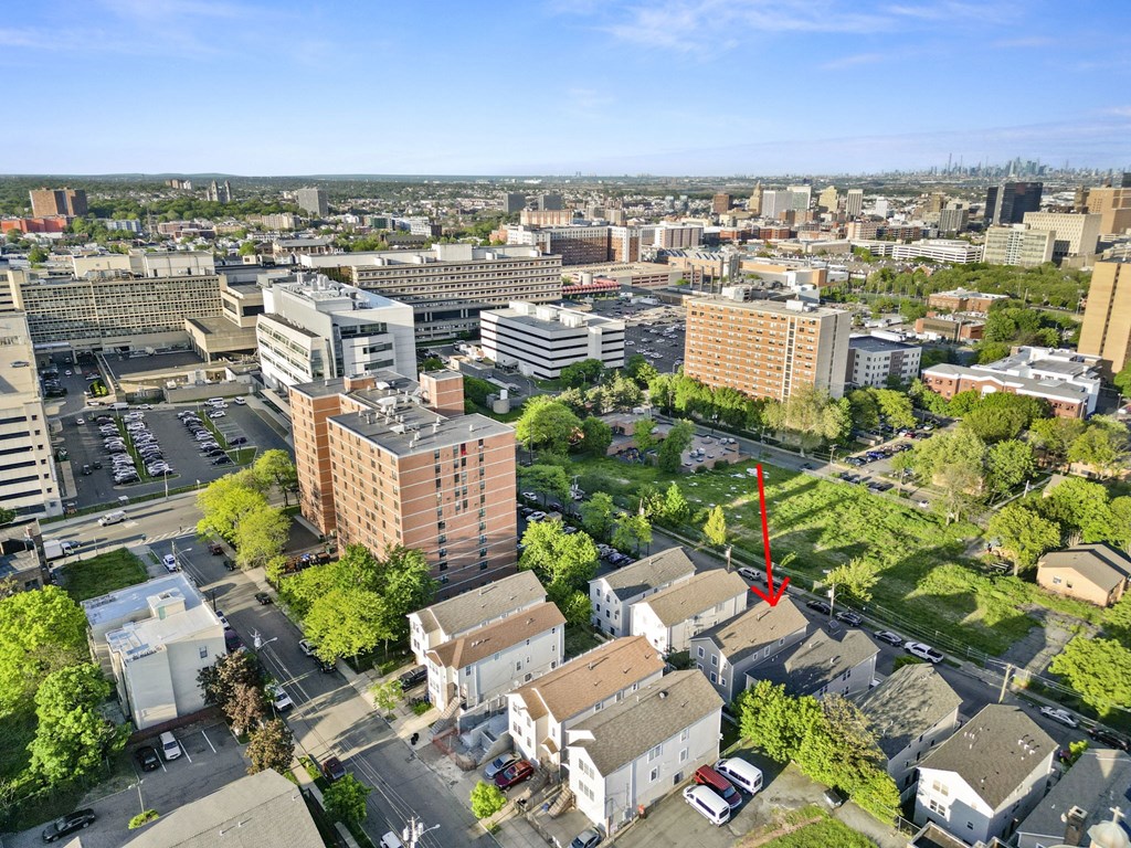 an aerial view of a city with tall buildings and trees