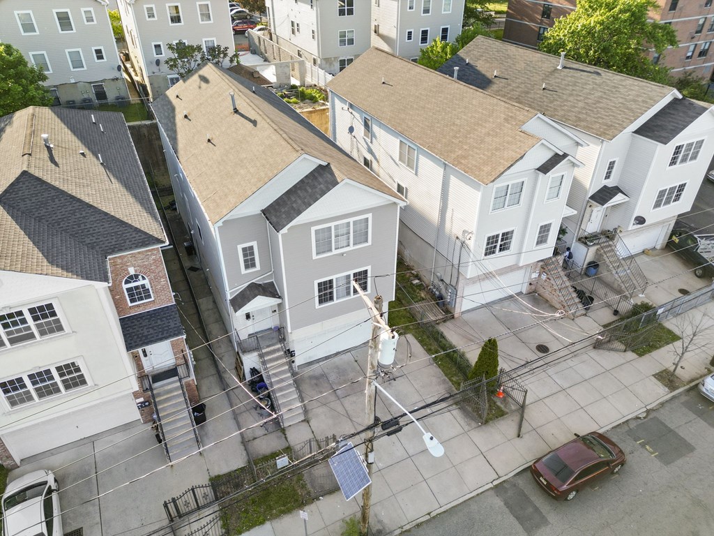 an aerial view of a group of houses on a city street
