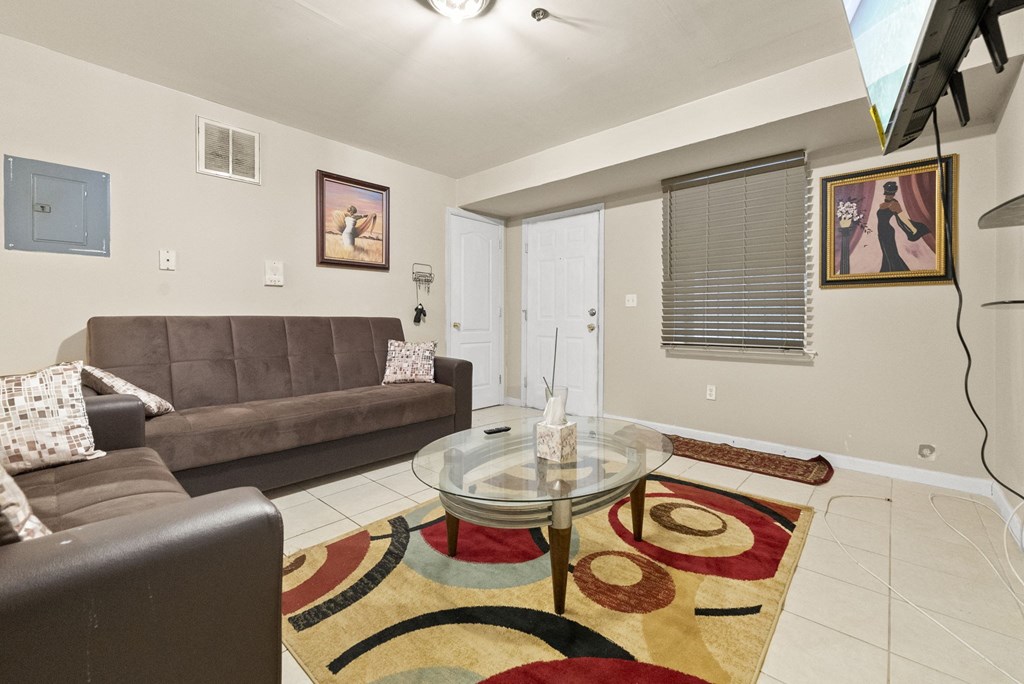 a living room with two couches and a glass coffee table
