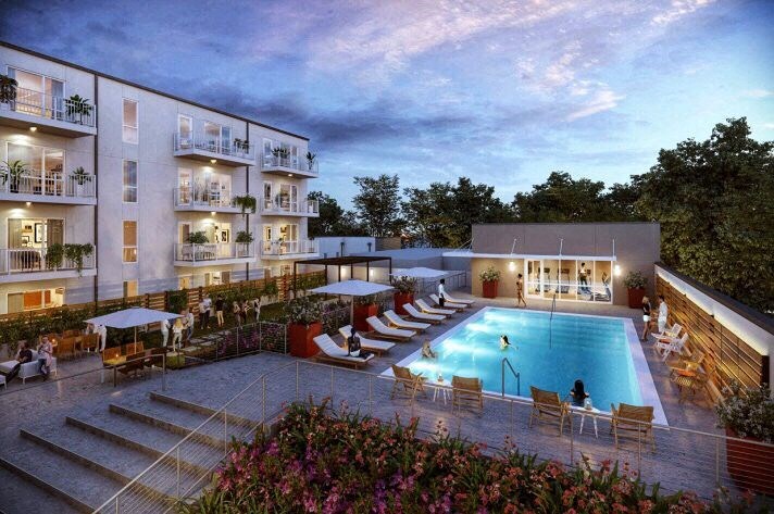 a swimming pool in front of a hotel at dusk