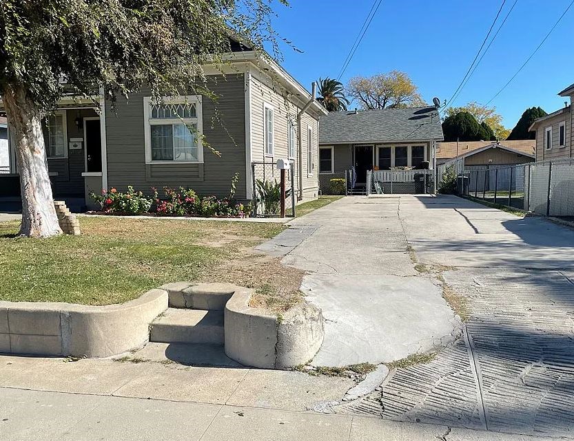 a street with some cement steps in front of a house