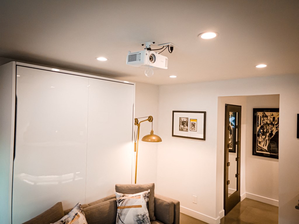 a living room with a couch and a ceiling fan
