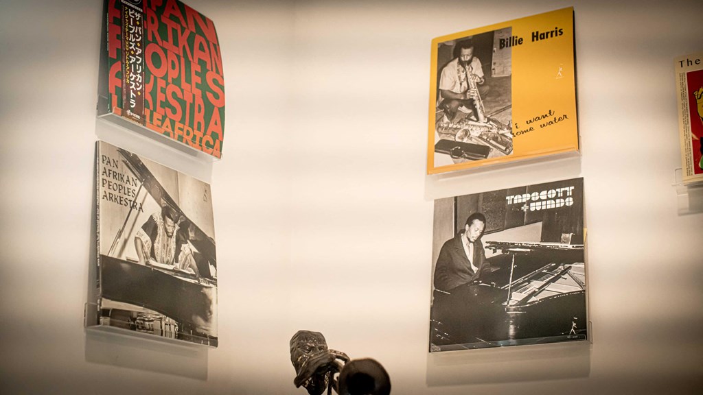 a wall with posters and a shoe on it