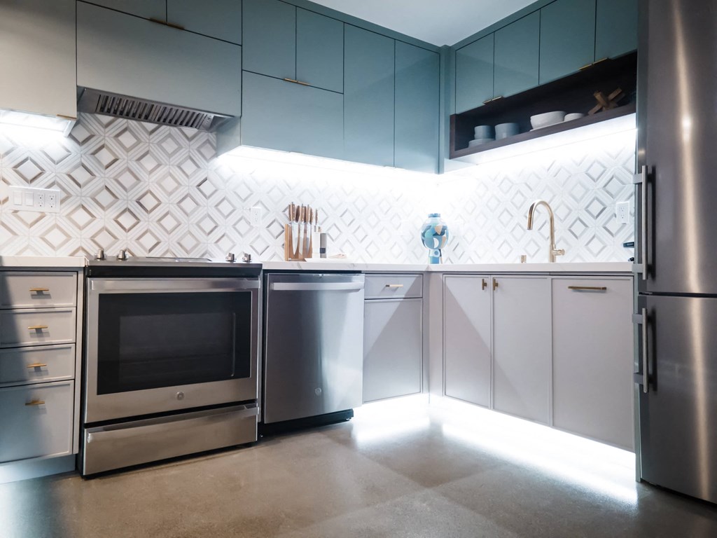 a kitchen with stainless steel appliances and white cabinets