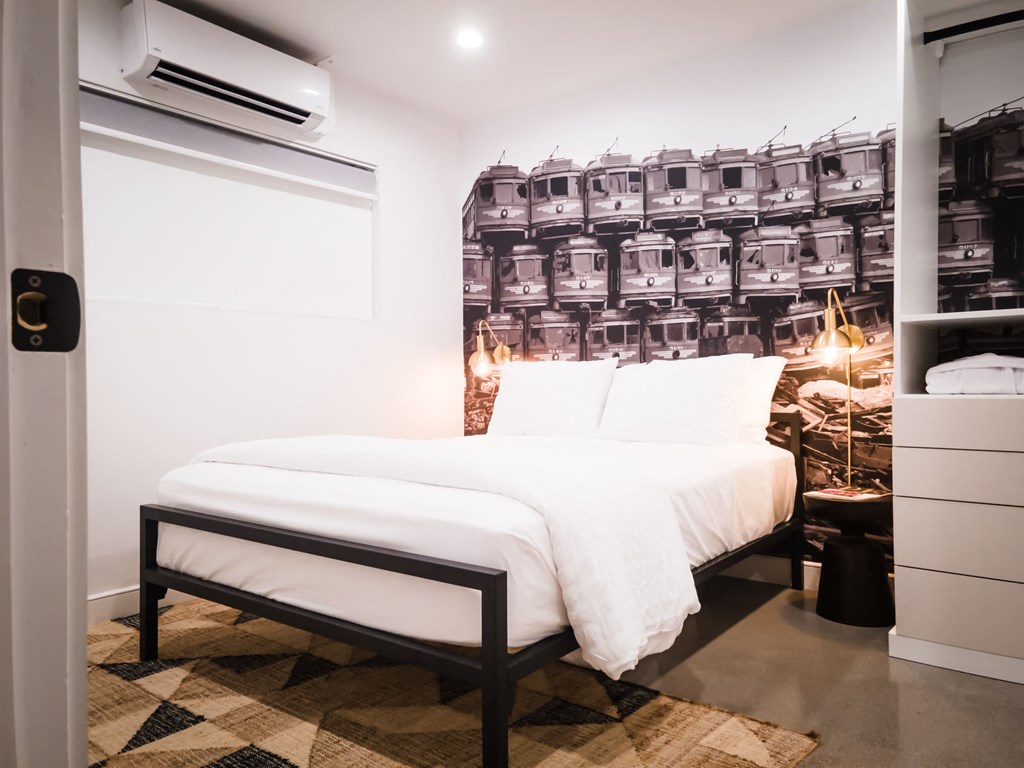 a small bedroom with a bed and a closet