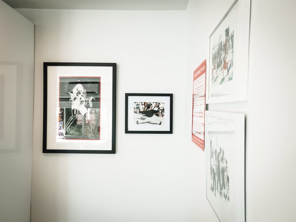 a wall in a room with three framed pictures on it