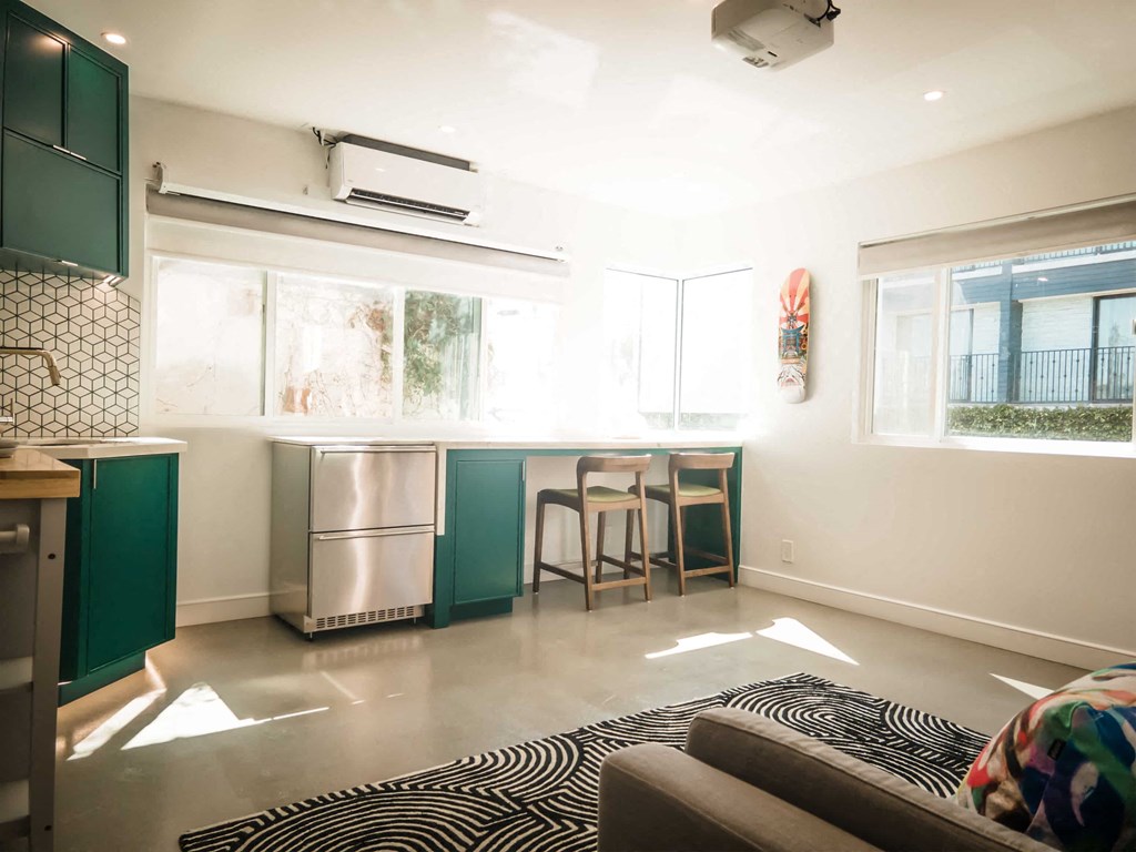 a small kitchen with a breakfast bar and a couch