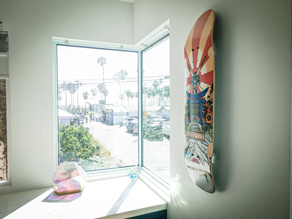 a surfboard hanging on a wall next to a window