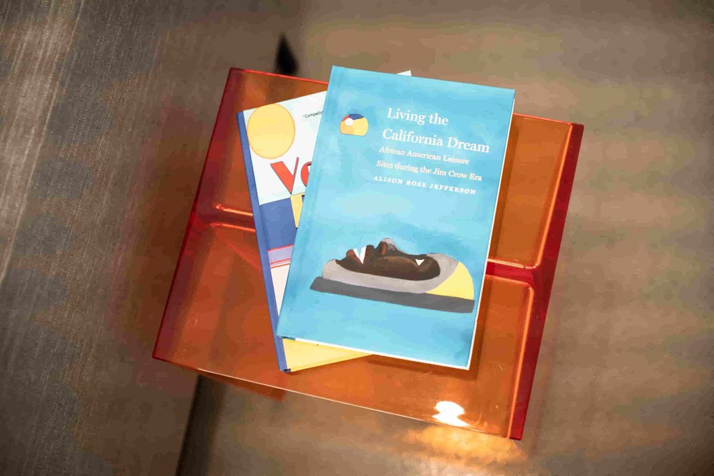 a book titled living the dream on a wooden table