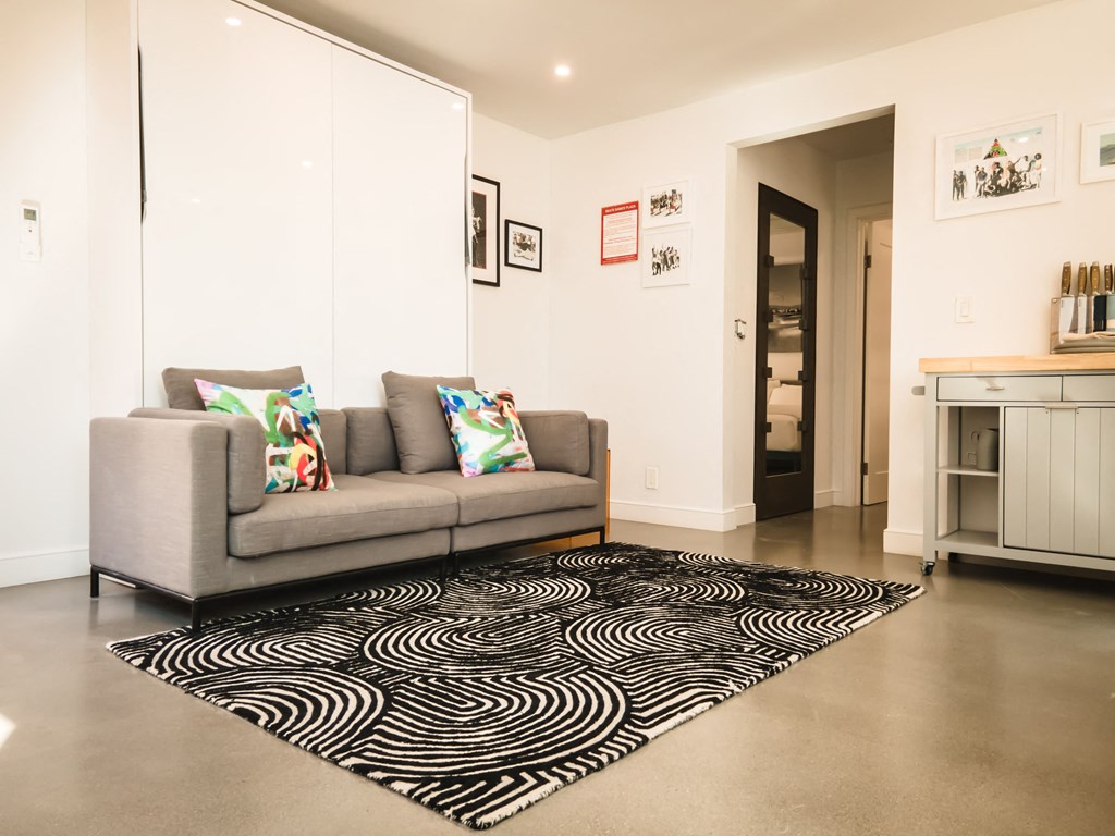 a living room with a couch and a rug