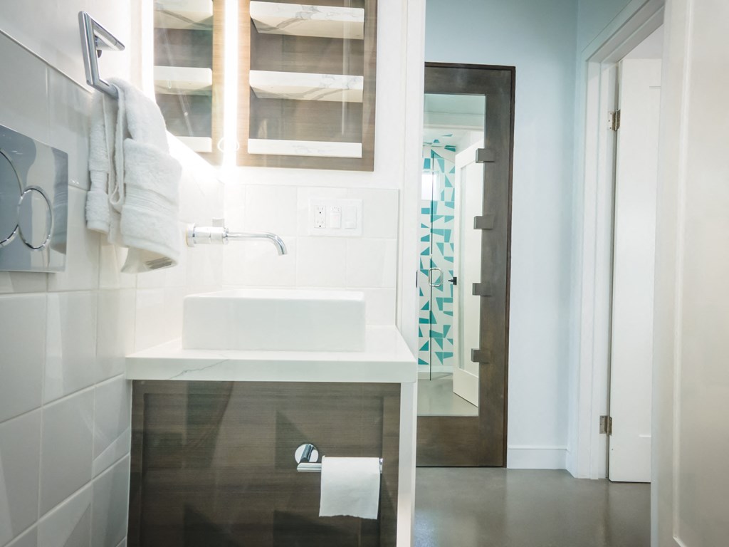 a small bathroom with a sink and a mirror and a shower