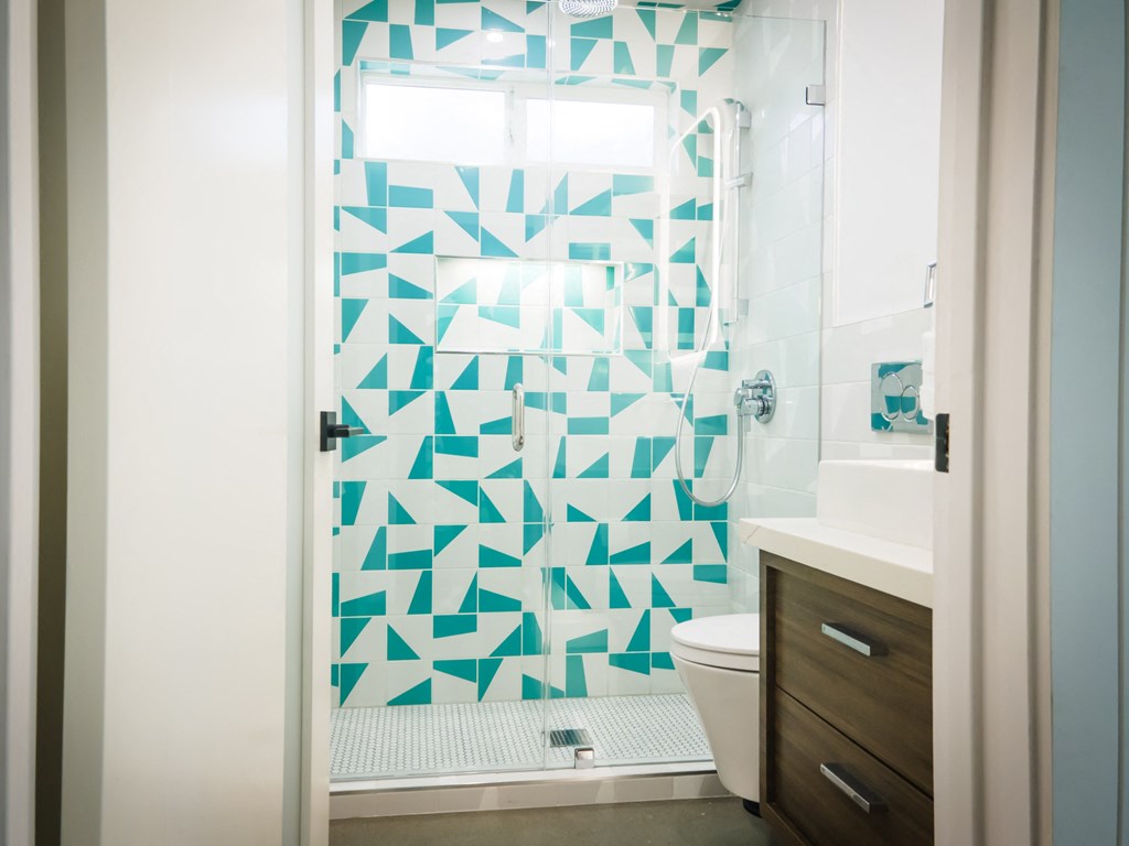 a bathroom with a blue and white shower curtain and a toilet