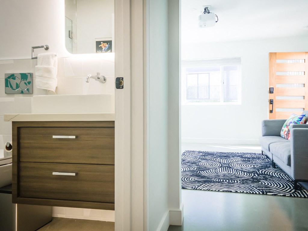 a bathroom with a sink and a mirror and a couch