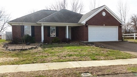 a brick house with a white garage door