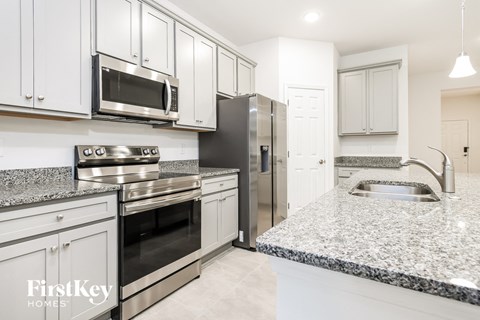 a kitchen with granite counter tops and stainless steel appliances