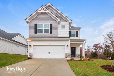 a white and gray house with a garage door