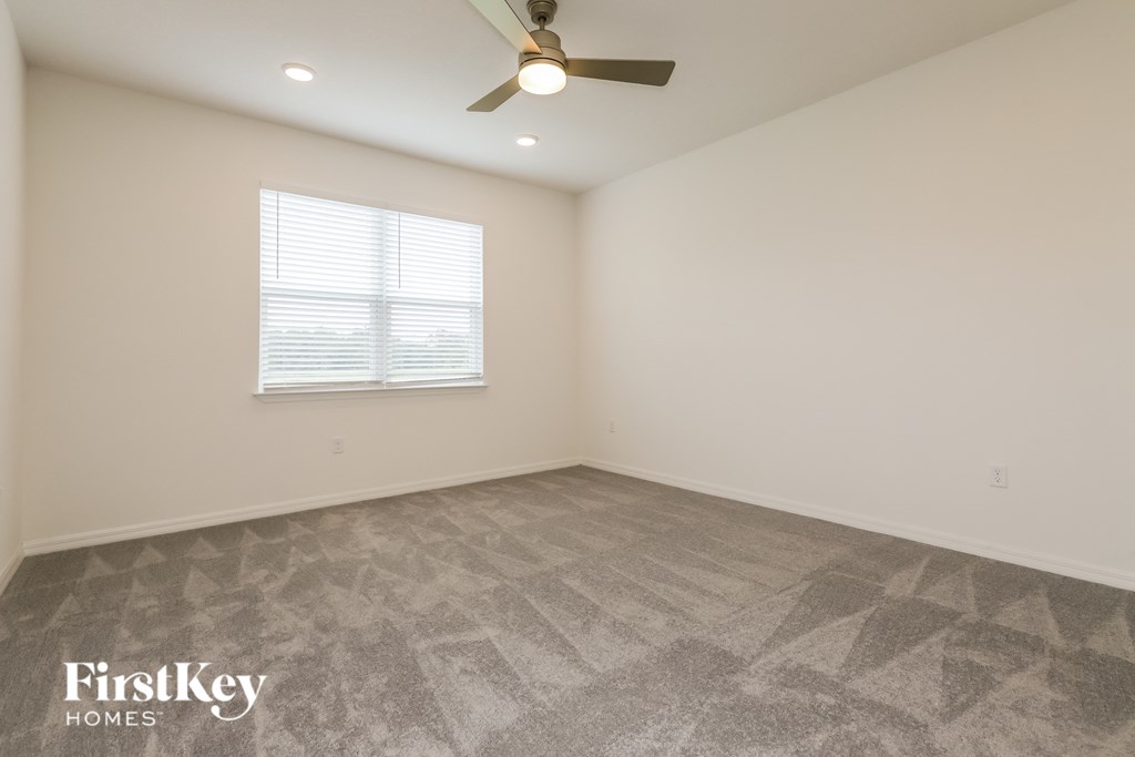 the living room of a new home with a ceiling fan